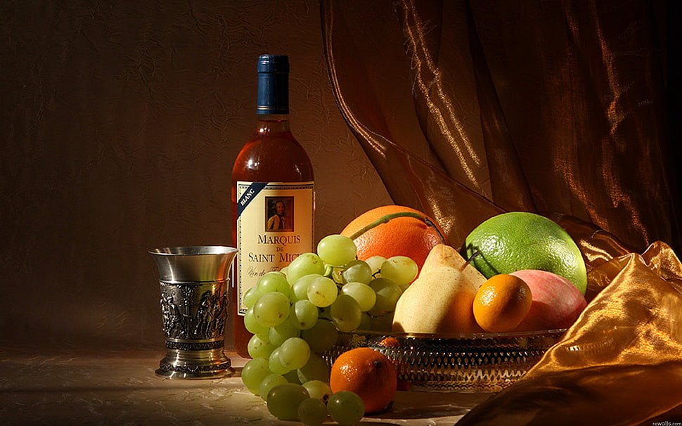 white labeled wine bottle beside fruits on basket HD wallpaper
