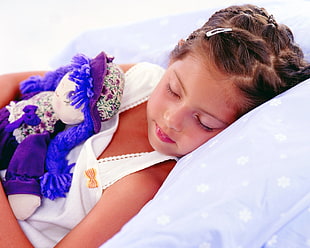 girl wearing white dress laying on bed