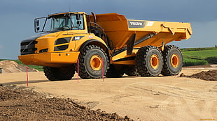 yellow and black dump truck under blue sky