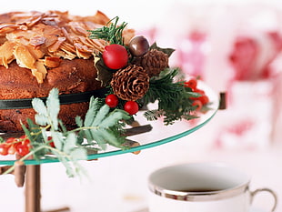 Christmas-themed baked food on top of clear glass stand