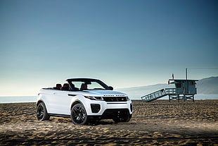 white convertible on brown sand during daytime HD wallpaper