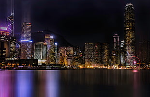 cityscape by water during nighttime HD wallpaper