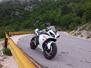 white and black sports motorcycle parked in gray road HD wallpaper