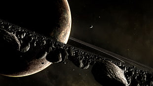brown planet and black asteroids photo