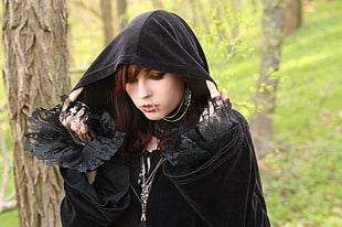 woman wearing black cloak with black lace sleeve