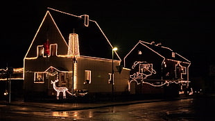 photo of black house filled with string light during nighttime