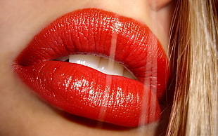 close up photography of woman red lipstick