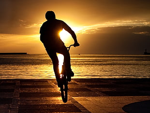 time lapse photography of man riding bicycle HD wallpaper