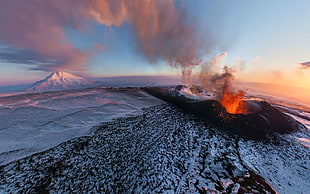volcano erupting during golden hour