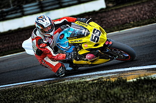 man in red and white racing jacket riding yellow Suzuki sport bike HD wallpaper