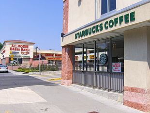 close-up photo of beige concrete Starbucks Coffee building