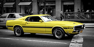yellow coupe car on road at daytime