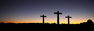 silhouette photo of three crosses