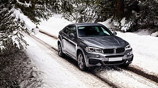 gray BMW sedan on snowy road HD wallpaper