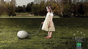 girl in brown dress holding gray balloon photo
