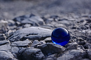 tilt shift lens photography of blue marble ball