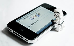 storm trooper figure beside black iPhone 5
