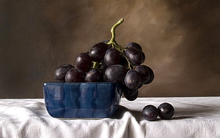 still life oil painting of grapes on blue bowl