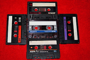 black and red electronic device, cassette, tape, music, red background