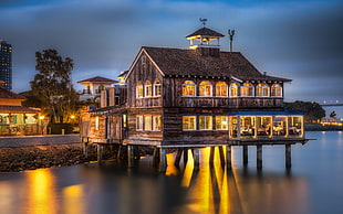 wooden restaurant on the body of water during daytime HD wallpaper