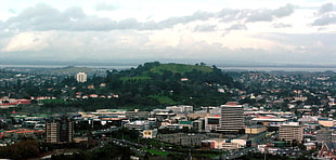concrete city near a green mountain