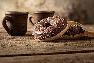 two doughnuts, wooden surface, brown, cup, food