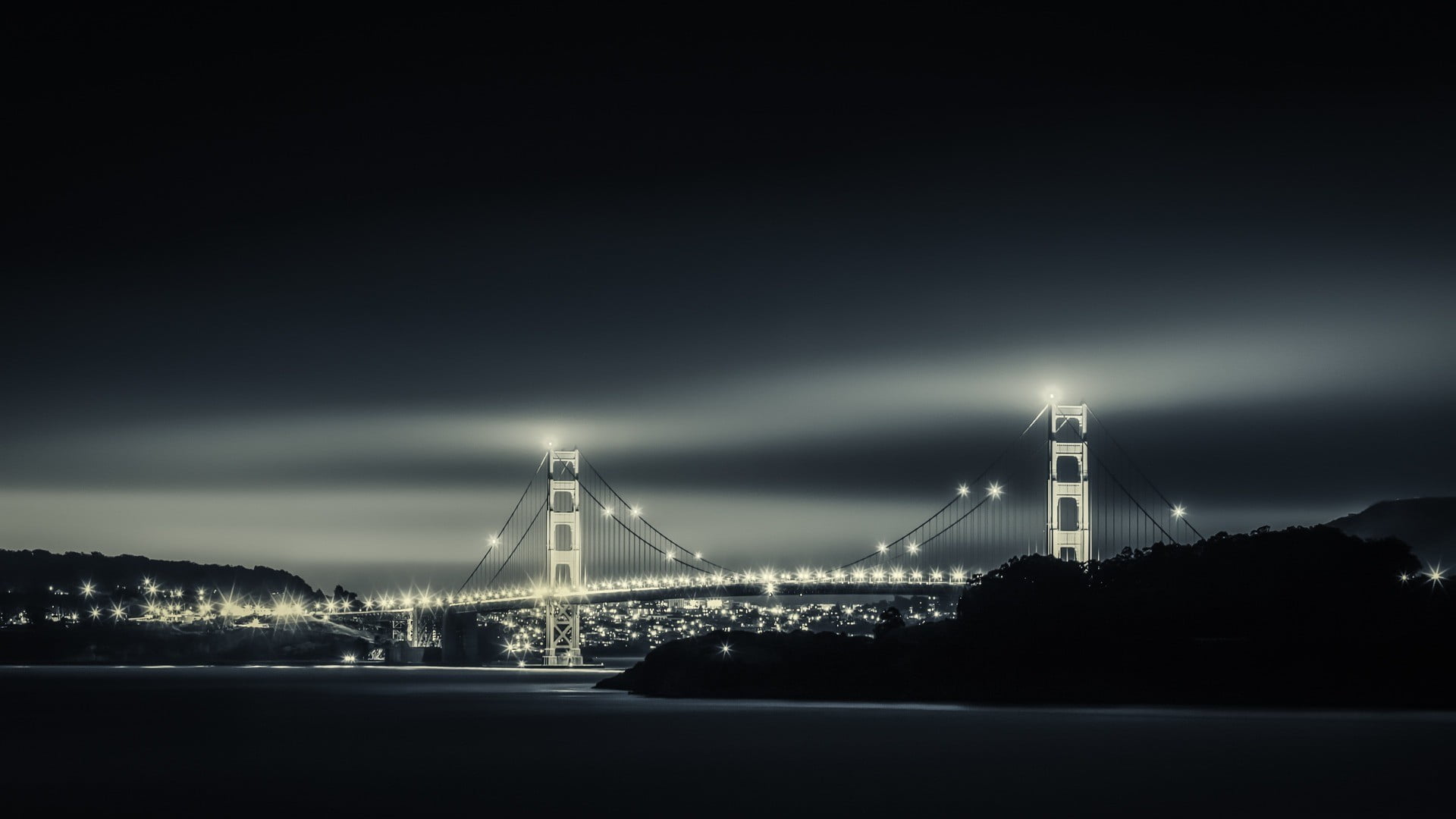 grayscale photograph of lighted Golden Gate Bridge