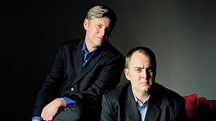 two men in black suit jacket photo