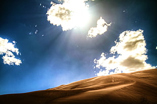 low angle photography of sand dunes under calm sky during daytime HD wallpaper