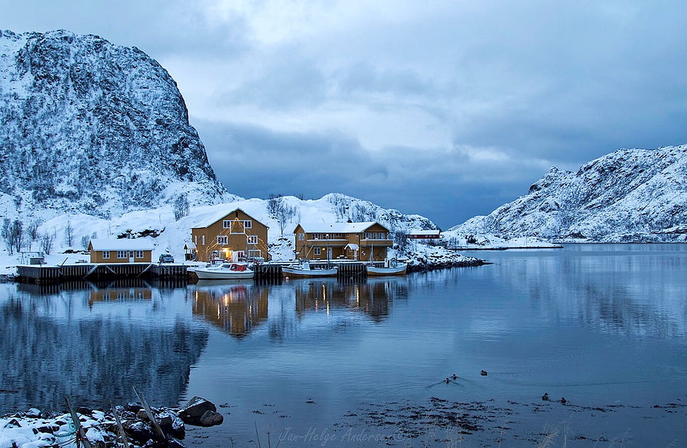 photo of brown wooden houses beside body of water during winter HD wallpaper