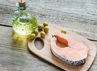 sliced fish on brown wooden chopping board