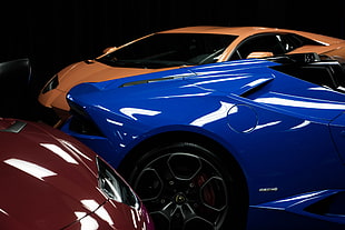 three orange, blue, and red sports cars HD wallpaper
