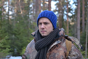 man wearing blue beanie in the middle of forest during daytime HD wallpaper