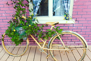yellow plant pot bicycle rack near bricked purple structure