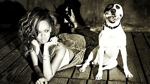 greyscale photo of Rihanna lying on floor near dog
