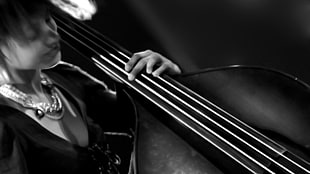 person playing cello grayscale photo