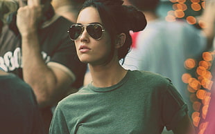 woman in green crew-neck shirt with Ray-Ban aviator sunglasses