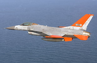 gray and orange aircraft flying in mid air photography