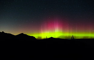 northern lights over mountain silhouette