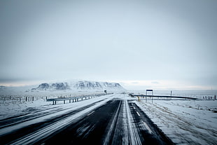 black and gray road with snow at daytime