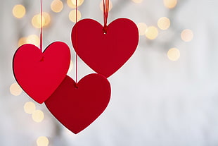 shallow focus photography of three red heart hanging decors