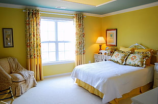 bedroom with turned on table lamp during daytime