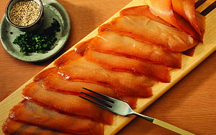stainless steel fork on sliced ham