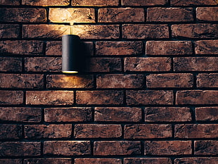 turned on light sconce on brick wall HD wallpaper