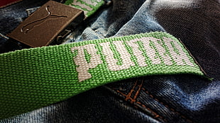 green Puma bag strap, Puma, jeans, belt, closeup