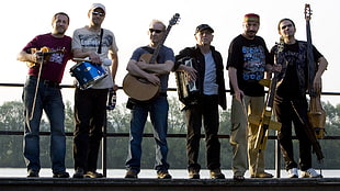 six men standing near bridge