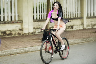 woman riding on hardtail bicycle during daytime