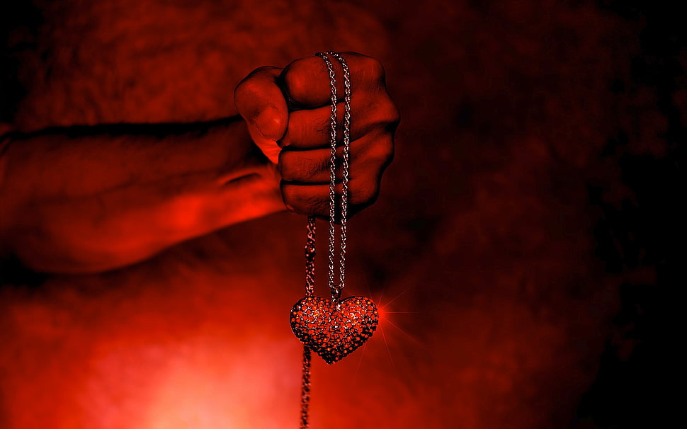 person holding heart pendant necklace HD wallpaper