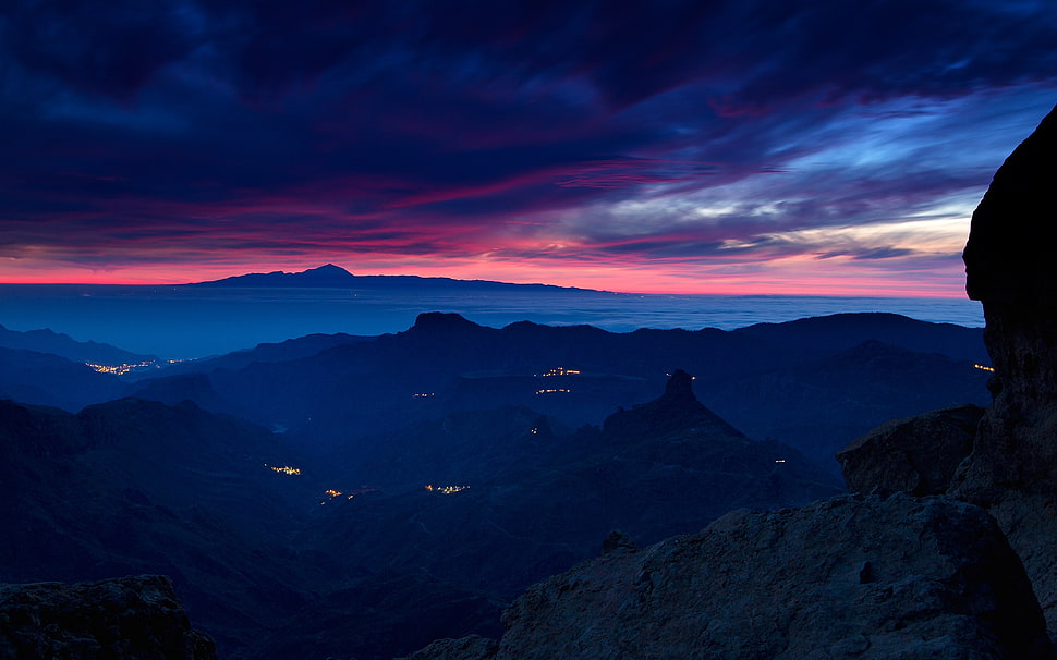 mountain ridge under cloudy sky during sunrise HD wallpaper