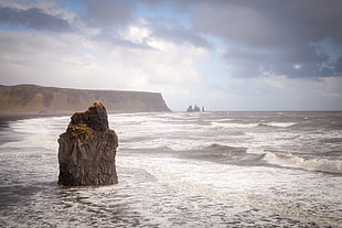 rock monolith on sea water